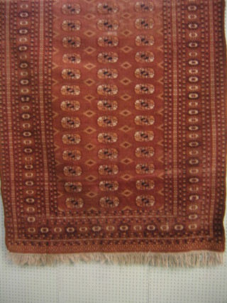 A tan ground Bokhara rug with 45 octagons to the centre 70 1/2" x 48"