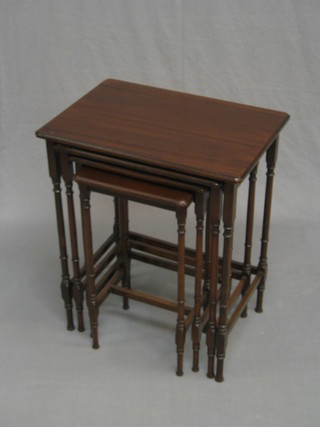 An Edwardian quartetto of interfitting tables, raised on turned supports