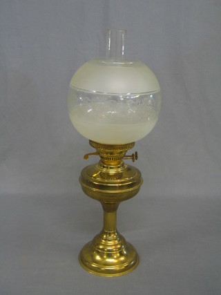 A 20th Century brass oil lamp complete with clear glass chimney and shade