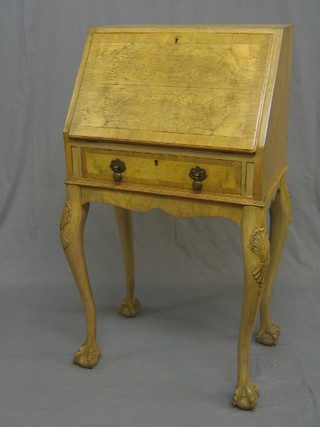 A bleached walnut bon heur du jour, the fall front revealing a well fitted interior, the base fitted 1 long drawer, raised on cabriole ball and claw supports 22"