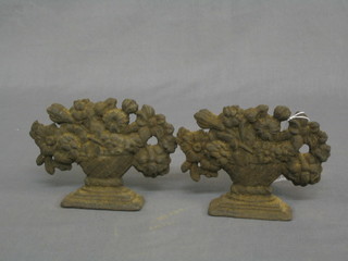 A pair of 19th Century cast iron book ends/door stops in the form of urns of flowers 6"