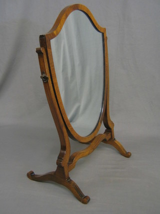 A 19th/20th Century shield shaped dressing table mirror contained in a mahogany swing frame