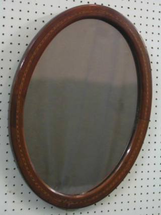 An Edwardian oval plate wall mirror contained in an inlaid mahogany frame 19 1/2"   
