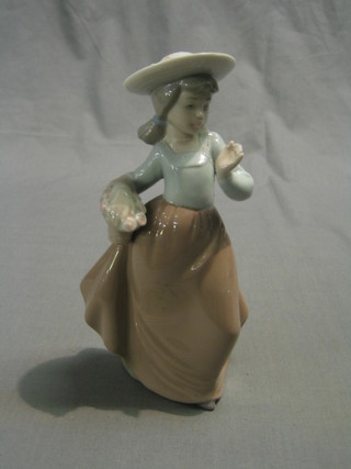 A Nao figure of a standing girl with basket 7" (hands damaged)