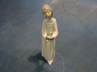 A Lladro figure of a standing girl with chamber stick, base impressed 4868, 9"
