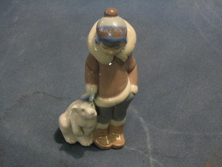 A Lladro figure of a standing boy with baby polar bear, base marked D-12M 6"