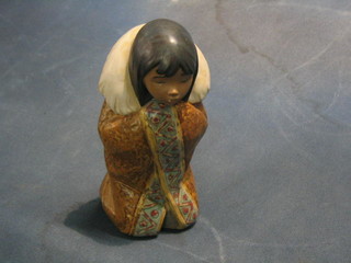 A Lladro figure of a kneeling Eskimo girl, base incised RL, 8"