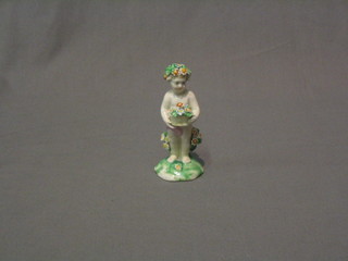 A 19th Century Derby porcelain figure of a standing cherub with floral encrusted decoration 4" 