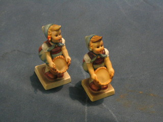 A pair of Goebel figure of girls with baskets "Little Helper" (1 f and r, 1 with chip to base)