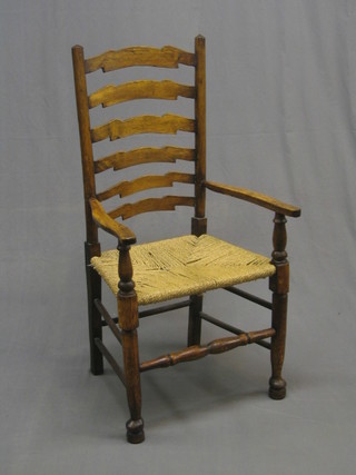 A 19th/20th Century elm ladder back carver chair with woven rush seat