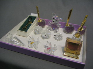 A Swarovski glass key ring in the form of a bag of golf clubs, a do. glass model of a yacht, 3 glass hedgehogs (some spikes missing), 2 glass flower heads, do. teddybear, a paperweight/photograph frame and 4 desk pen holders