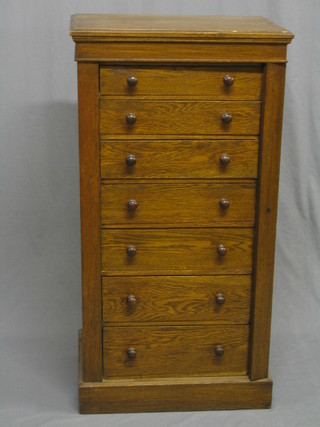 A Victorian oak Wellington chest fitted 7 long drawers, raised on a platform base 23"