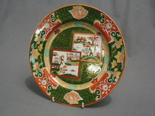 A 19th Century Masons Ironstone pottery plate decorated stylised Willow Pattern with green and red banding, the base impressed 5/04 Masons patented Ironstone and with red patented Masons mark 10 1/2"