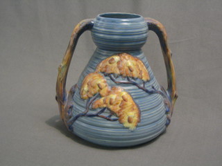 A Carltonware twin handled pottery vase decorated stylised trees, the base marked Carltonware 8"
