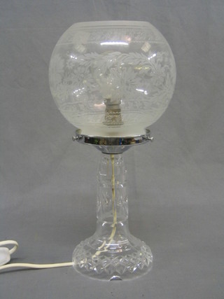 A cut glass table lamp with etched glass shade