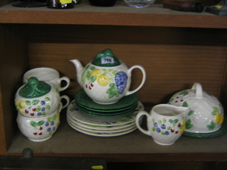 A 15 piece Wade Pottery tea service decorated fruit comprising teapot, cheese dish and cover, 4 plates 8" (some crazing), 4 saucers, 3 cups, lidded sugar bowl and cream jug 