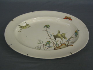 A Copeland oval pottery meat plate decorated storks 17"