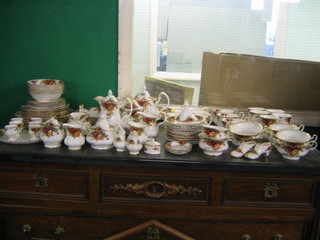 An 86 piece Royal Albert Old Country Rose pattern tea/dinner service comprising 5 dinner plates 10 1/2" (some rubbing to the gilding), 6 side plates 8 1/2", 2 oval bowls 9", 6 cereal bowls 6 1/2", a twin handled bread plate 9", 6 egg cups (rubbing to banding), sauce boat and stand, preserve jar and cover, large teapot, small teapot, hotwater jug, lidded sucrier, cream jug (handle f), 6 tea plates 6 1/2", (banding rubbed), 3 breakfast cups (1 cracked), 5 tea cups (rubbing to banding), 5 mugs (rubbing to banding), large cream jug, small cream jug, 11 saucers (1 cracked and some rubbing to banding), 6 twin handled soup bowls, sugar bowl 4", 2 sugar bowls 3", 3 ashtrays? 3", an oval mustard pot? 2", salt and pepper, 2 model shoes and a coffee pot lid