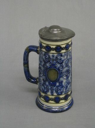 A 19th Century pottery salt glazed jug with pewter mount 8"