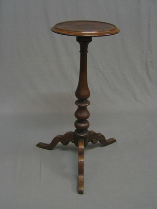 A Victorian turned mahogany kettle/jardiniÃ¨re stand, raised on pillar and tripod supports