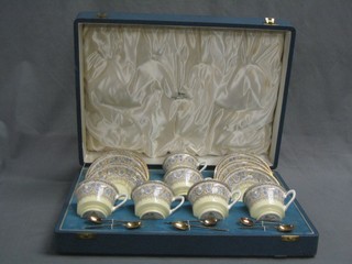 A Royal Worcester 12 piece Lady Evelyn pattern tea service comprising 6 cups and 6 saucers (1 cup chipped), together with 6 silver gilt coffee spoons, by Mappin & Webb, the tea service with brown Royal Worcester mark, cased