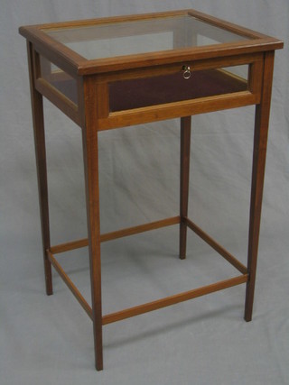 A 20th Century mahogany framed bijouterie table with hinged lid, raised on square tapering supports united by a box stretcher 19"
