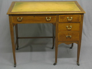 An Edwardian inlaid mahogany desk, the top with green leather inset writing surface, fitted 1 long drawer flanked by 3 short drawers, raised on square tapering supports 36"