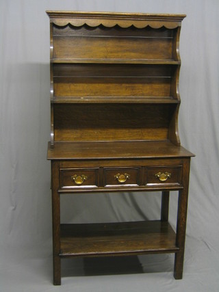 An Edwardian oak dresser, the raised back with moulded cornice fitted 2 shelves, the base fitted 1 long drawer above a pot board, raised on square tapering supports 36"  