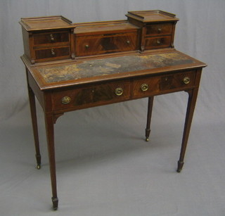 An Edwardian inlaid mahogany writing table, the raised back fitted a stationery box with hinged lid flanked by 4 drawers, the top inset a writing surface above 2 short drawers, raised on square tapering supports ending in spade feet, (writing surface needs re-leathering, 1 handle missing to drawer and slight damage to left hand leg) 36"