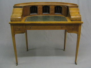 A handsome Edwardian Carlton House writing table, the crescent shaped raised back fitted various cupboards, drawers and pigeon holes, having an inset tooled leather writing surface, fitted 1 long drawer flanked by 2 short drawers and raised on square tapering supports ending in brass caps and castors 42"
