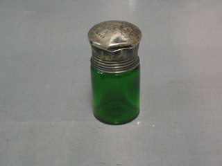 A green glass salt bottle with silver lid (dents)