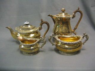 A 19th Century Georgian style 4 piece silver plated tea service comprising oval teapot, hotwater jug, twin handled sugar bowl and cream jug, all with cast borders