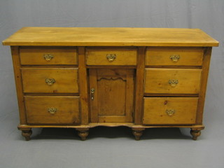 A 19th Century French stripped and polished pine sideboard, fitted 3 long drawers to the top, cupboard to the centre and flanked by 4 short drawers, raised on bracket feet 49"