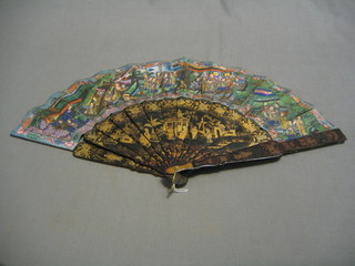 A  19th Century Oriental lacquered fan, the tips with painted panels decorated court figures with applied ivory heads