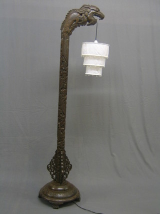 A 20th Century Oriental carved hardwood standard lamp in the form of a dragon