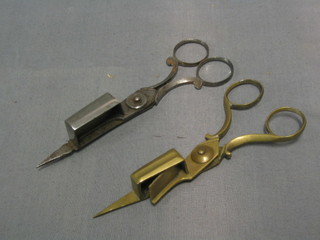 A pair of 18th Century polished steel candle snuffers and a pair of brass ditto