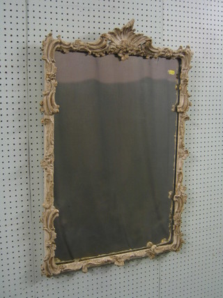 A 19th Century rectangular plate mirror contained in a white painted Rococo style plaster frame 35"