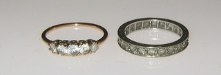 A gold dress ring set 5 "diamonds" and an eternity ring
