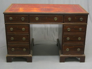 A Georgian style mahogany kneehole pedestal desk with tooled red leather tooled inset writing surface, fitted 9 drawers, raised on bracket feet 46"