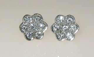 A pair of cluster style earrings each set 7 diamonds (approx 1ct)