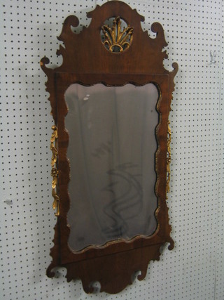 A 19th Century Chippendale style plate mirror contained in a walnut frame 38" (small chip to veneer on left hand)