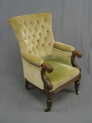 A handsome William IV mahogany tub back library chair upholstered in green buttoned material, raised on brass caps and castors