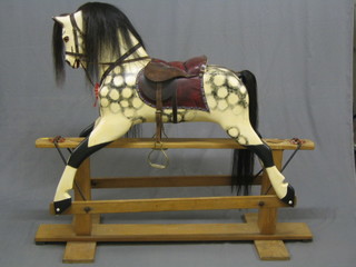 A dappled grey rocking horse on stand