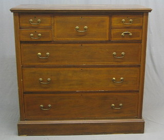An Edwardian inlaid mahogany chest with crossbanded top, fitted 1 long drawer flanked by 4 short drawers above 3 long drawers, raised on a bracket base, (the top with slight damage to left hand corner, some ring and scratch marks), 48"