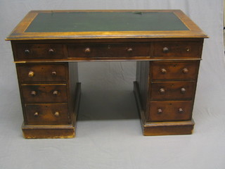 A Victorian walnut kneehole pedestal desk with inset tooled leather writing surface above 9 drawers 48"