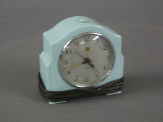 A 1950's Smiths electric clock contained in an arched green case 5"