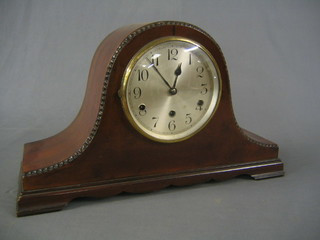 A 1930's chiming mantel clock with silvered dial and Roman numerals, contained in a mahogany Admiral's hat shaped case