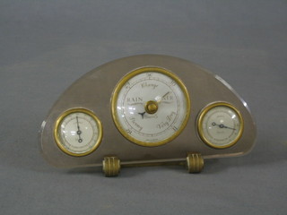 A 1930's Art Deco Smiths barometer with thermometer and humidity meter contained in an arched perspex case