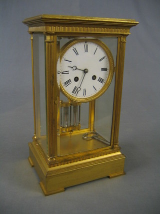 A 19th Century French striking 4 glass clock with circular porcelain dial and Roman numerals, with twin mercury pendulum, contained in a 4 glass case (heavily chipped to front bevelled panelled door of case) 7"