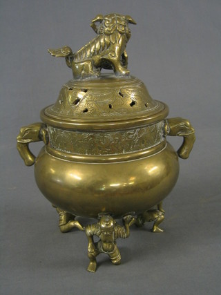 A 19th Century Eastern circular brass Koro with dog of fo finial, the base with seal mark supported by 3 kneeling attendants 12"